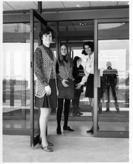 Three Girls Posing at College Entrance for Open House Advertisement