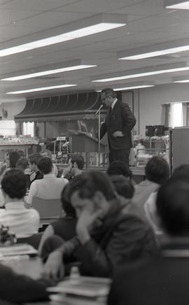 President Newnham Speaking at an Assembly in the Finch Campus Cafeteria